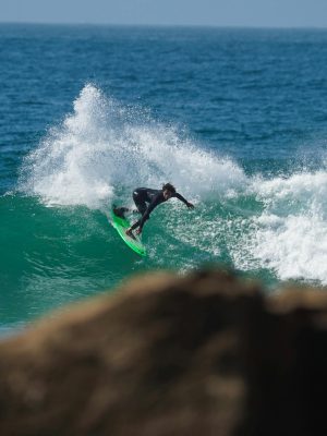 Surfing action captured at Taghazout, Morocco's vibrant coastline, showcasing wave-riding skill.